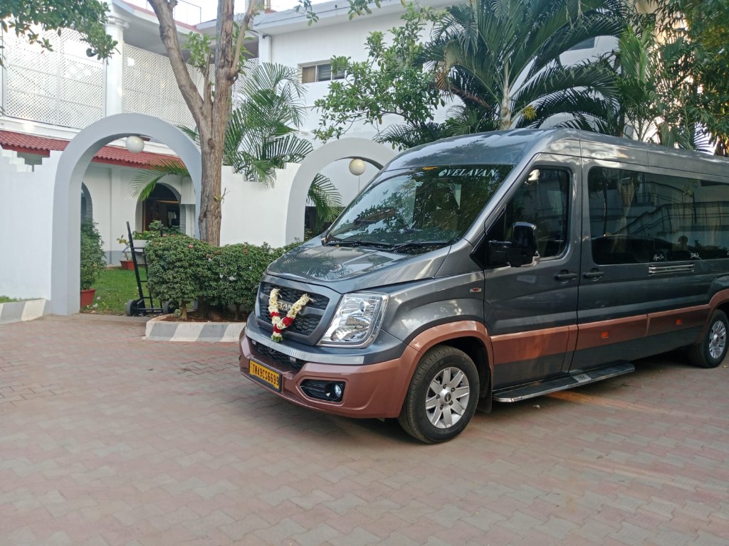 Decorated Force Urbania van with flower garland at resort entrance